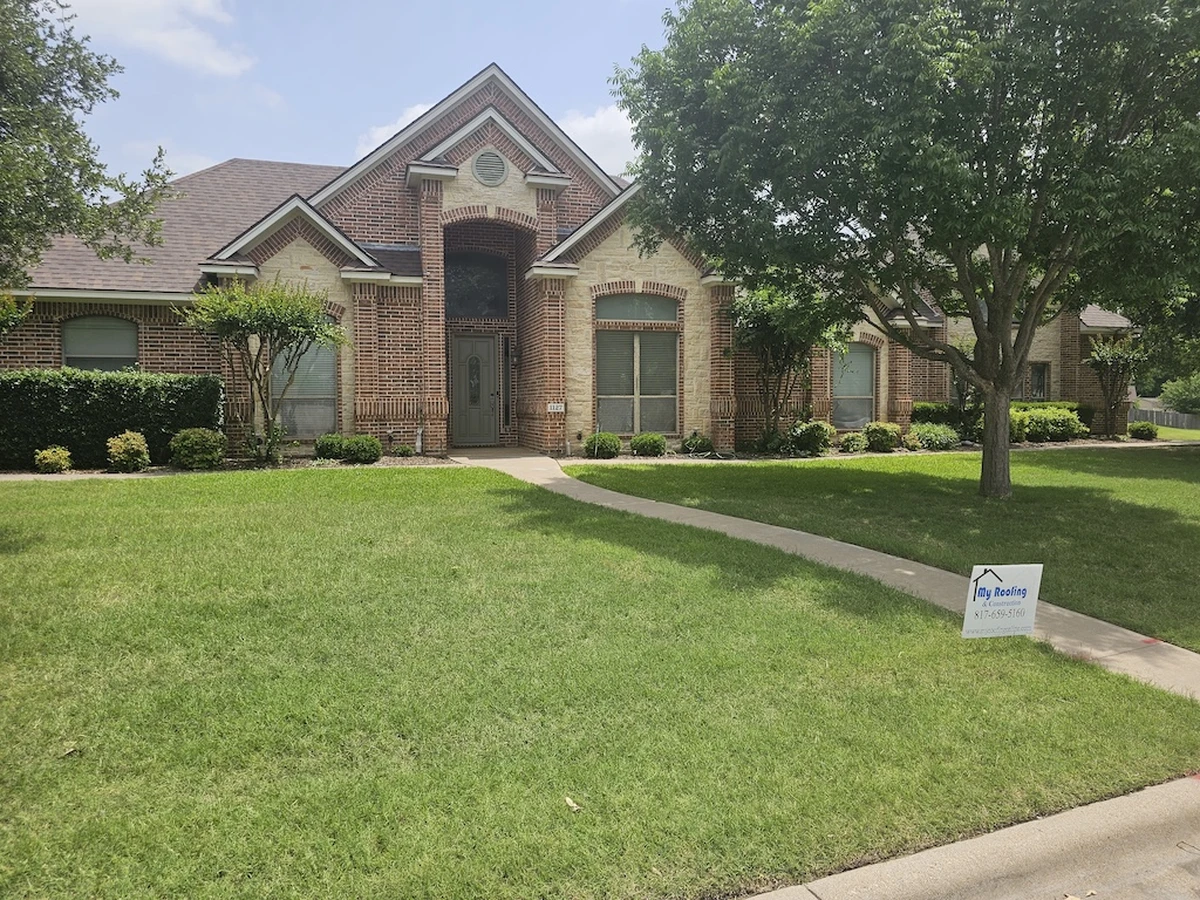 Brick home with new roof in Cleburne, TX by My Roofing