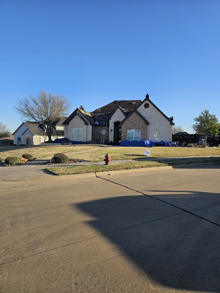 Roof replacement in progress with scaffolding in Johnson County, TX